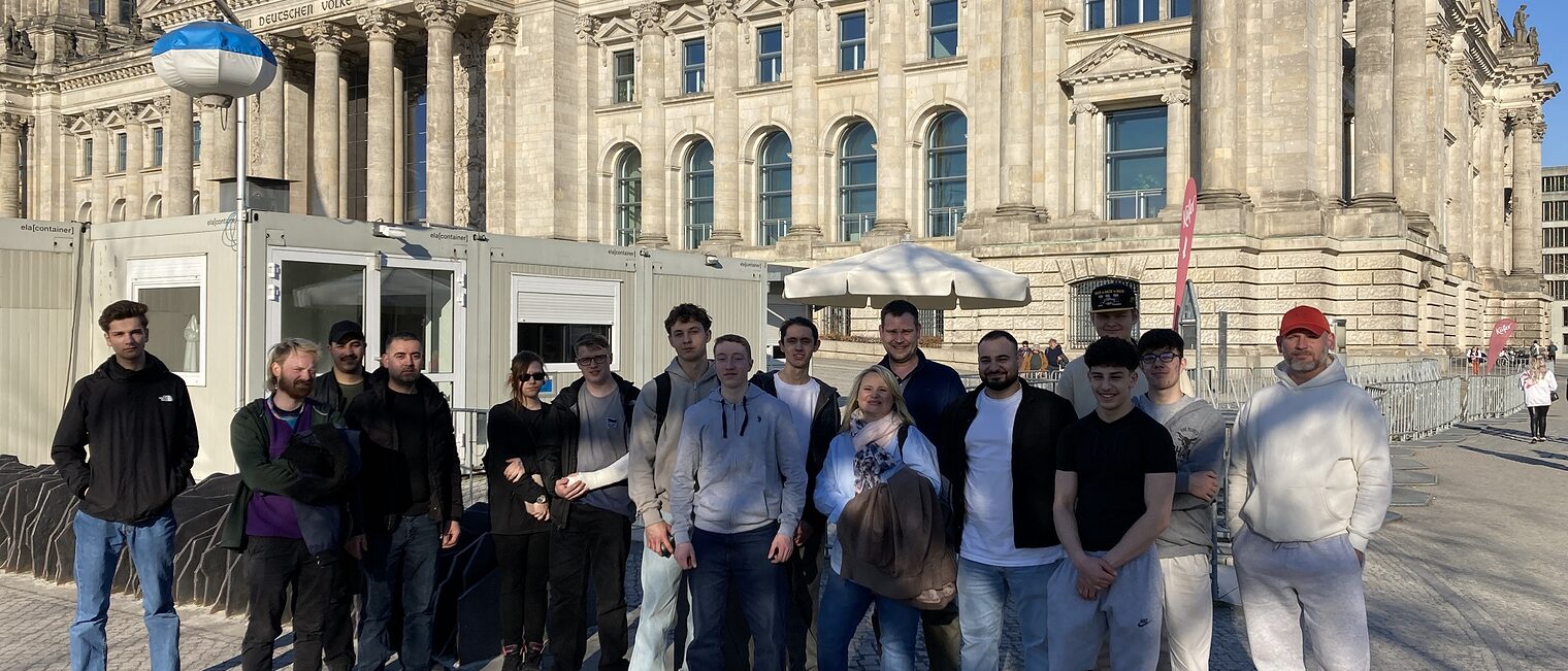 Ein Gruppenbild der Azubis, die vor dem Gebäude des Bundestags posieren